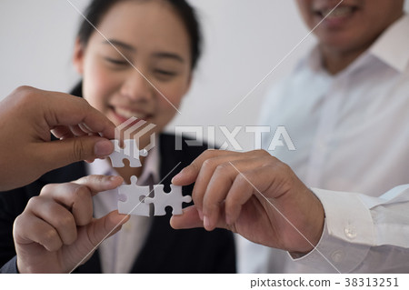 business people assembling piece of puzzle together. co worker team solving problem. teamwork collaboration connection concept business people assembling piece of puzzle together. co worker team solving problem. teamwork collaboration connection concept 38313251