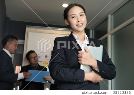 businesswoman smile at business meeting. businessman discuss data at office. freelancer hold digital tablet in her arms at conference businesswoman smile at business meeting. businessman discuss data at office. freelancer hold digital tablet in her arms at conference 38313386