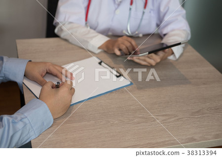 patient complete questionaire in medical office. man fill out health insurance form at hospital patient complete questionaire in medical office. man fill out health insurance form at hospital 38313394