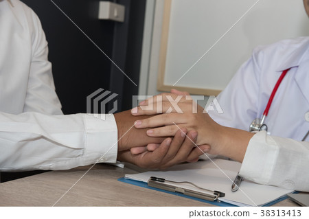 doctor holding patient hand & comforting him for bad news. physician support & encourage a man for medical examination. encouragement & empathy concept 38313413