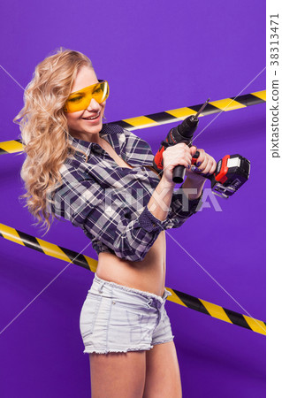 Young builder girl in chechered shirt, glasses and Young builder girl in chechered shirt, glasses and 38313471