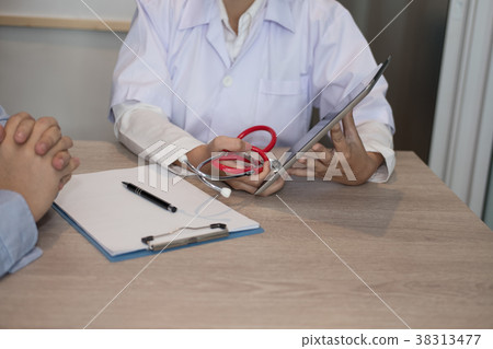 doctor showing test result on tablet to patient at hospital. physician talk & give advice to man about his health at medical office doctor showing test result on tablet to patient at hospital. physician talk & give advice to man about his health at medical office 38313477