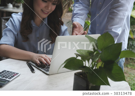 young business people having a meeting. businessman & businesswoman working with computer at cafe. startup man & freelance woman discussing idea at coffee shop. discussion, teamwork, collaboration, corporate concept. young business people having a meeting. businessman & businesswoman working with computer at cafe. startup man & freelance woman discussing idea at coffee shop. discussion, teamwork, collaboration, corporate concept. 38313478