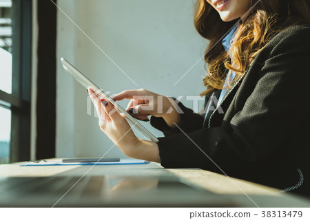 businesswoman using tablet computer at workplace. startup woman working with computer at office. young female entrepreneur analyze accounting market data. businesswoman using tablet computer at workplace. startup woman working with computer at office. young female entrepreneur analyze accounting market data. 38313479