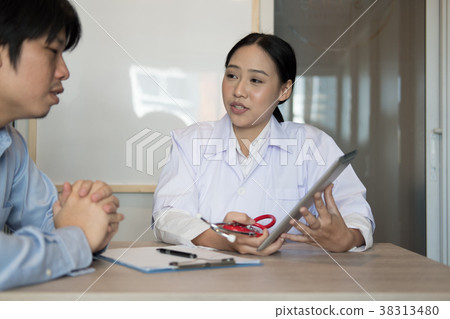 doctor showing test result on tablet to patient at hospital. physician talk & give advice to man about his health at medical office doctor showing test result on tablet to patient at hospital. physician talk & give advice to man about his health at medical office 38313480