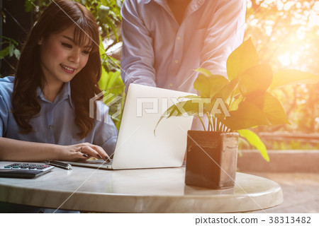 young business people having a meeting. businessman & businesswoman working with computer at cafe. startup man & freelance woman discussing idea at coffee shop. discussion, teamwork, collaboration, corporate concept. young business people having a meeting. businessman & businesswoman working with computer at cafe. startup man & freelance woman discussing idea at coffee shop. discussion, teamwork, collaboration, corporate concept. 38313482