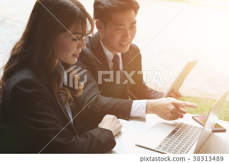 young business people having a meeting. businessman & businesswoman working with computer at cafe. startup man & freelance woman discussing idea at coffee shop. discussion, teamwork, collaboration, corporate concept. young business people having a meeting. businessman & businesswoman working with computer at cafe. startup man & freelance woman discussing idea at coffee shop. discussion, teamwork, collaboration, corporate concept. 38313489