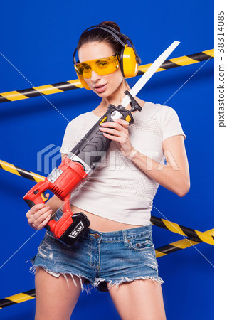 Young sexy builder girl in white top, denim shorts Young sexy builder girl in white top, denim shorts 38314085