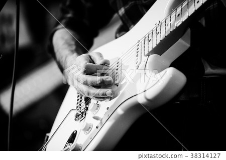 Artist playing electric guitar on the stage 38314127