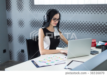 Beautiful young businesswoman in black dress 38316870