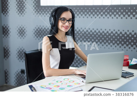 Beautiful young businesswoman in black dress 38316876