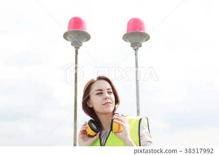 Attractive cute worker woman in green west and Attractive cute worker woman in green west and 38317992