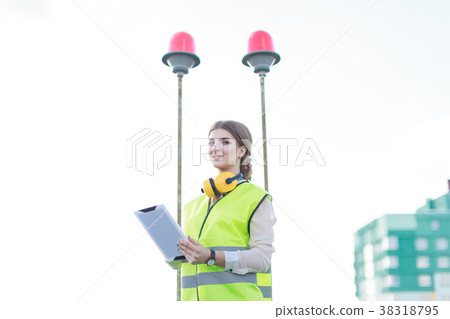 Young pretty woman in green west and earmuffs Young pretty woman in green west and earmuffs 38318795