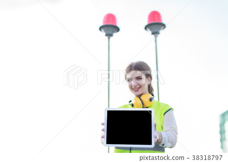 Young pretty woman in green west and earmuffs 38318797