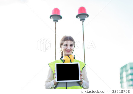 Young pretty woman in green west and earmuffs 38318798