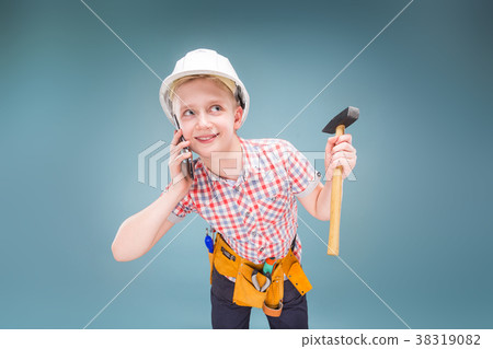 portrait of a young builder in a helmet and a tape portrait of a young builder in a helmet and a tape 38319082