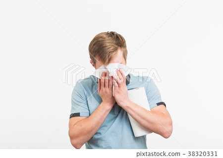 Young man has a runny nose on white background 38320331