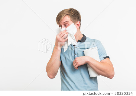 Young man with handkerchief. Sick guy isolated has Young man with handkerchief. Sick guy isolated has 38320334