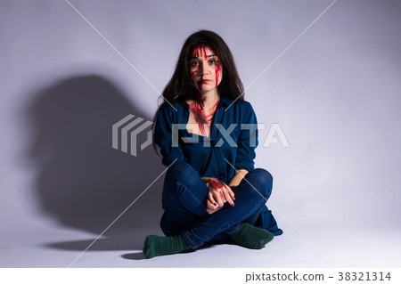 Rape battered bloody victim sad woman sits on the 38321314
