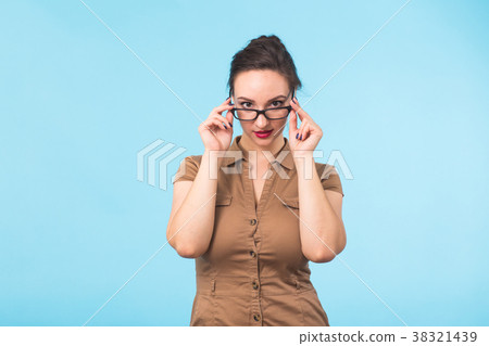Elegant cheerful brunette in eyeglasses smiling at 38321439