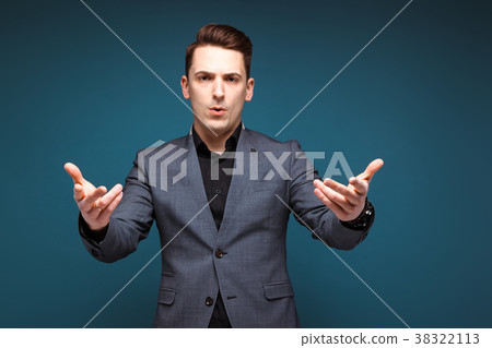 Young handsome businessman in grey jacket and 38322113