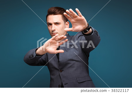 Young handsome businessman in grey jacket and 38322117