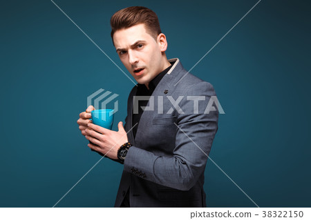 Young handsome businessman in grey jacket and 38322150