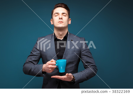 Young handsome businessman in grey jacket and 38322169