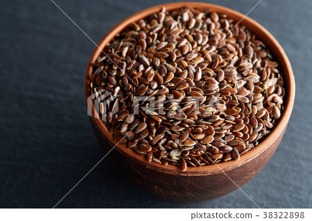 Many flax seeds are scattered in the background Many flax seeds are scattered in the background 38322898