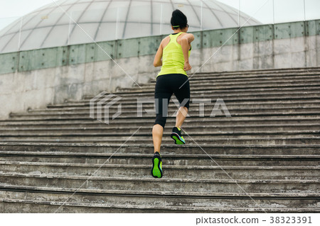 Young fitness sporty woman running upstairs Young fitness sporty woman running upstairs 38323391