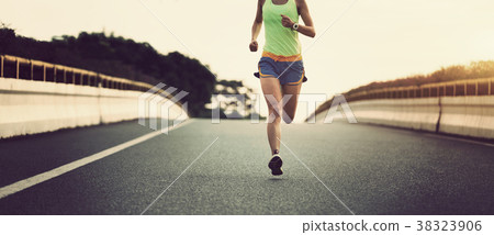 fitness asian woman runner running on city road 38323906