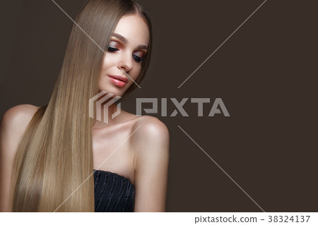 Beautiful blond girl with a perfectly smooth hair 38324137