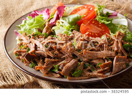 pulled spicy beef with fresh vegetables close-up pulled spicy beef with fresh vegetables close-up 38324595