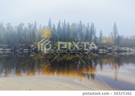 A misty morning on the bank of the taiga river 38325162