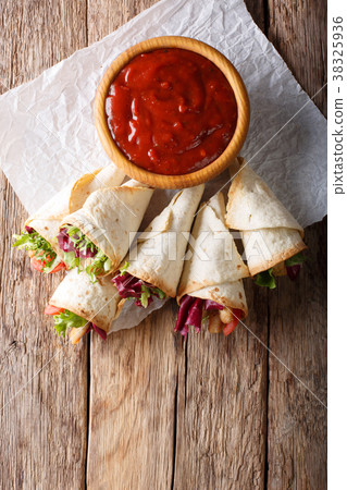 Delicious burrito with turkey, lettuce 38325936