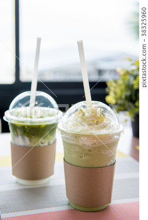 Green tea frappe and wipping cream in plastic cup Green tea frappe and wipping cream in plastic cup 38325960