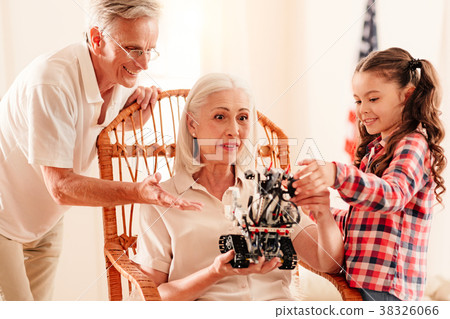 Adorable family playing with new robot toy 38326066
