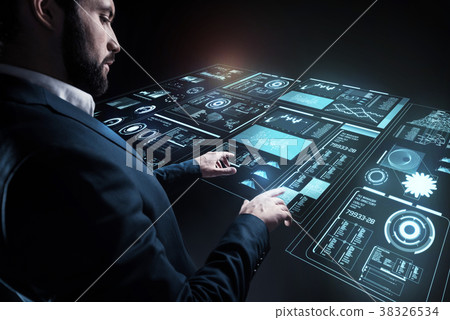 Careful specialist working with a tangible device 38326534