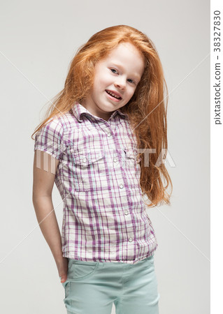 Cute redhead little girl in plaid shirt, bright 38327830