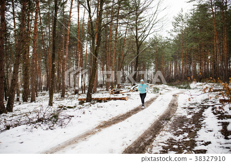 Senior woman jogging in winter nature. 38327910