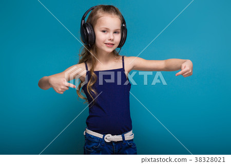 Pretty, little girl in shirt and earphones with Pretty, little girl in shirt and earphones with 38328021