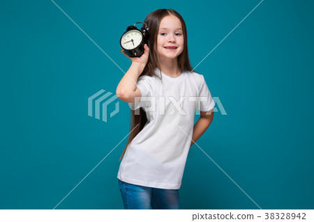 Cute girl in tee shirt with long hair hold the 38328942