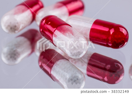 red-white capsules on a white background red-white capsules on a white background 38332149