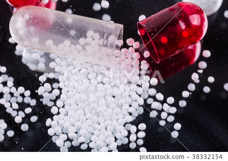 red-white capsules of them on a mirrored 38332154