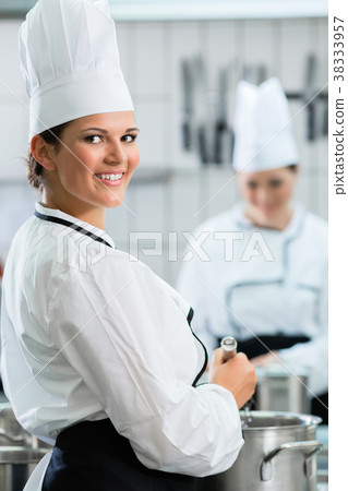 Female chefs at work in system catering 38333957