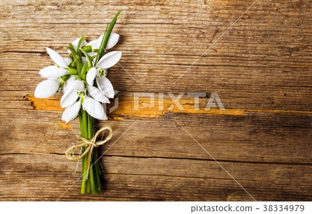 Snowdrop flowers on rustic wooden background Snowdrop flowers on rustic wooden background 38334979