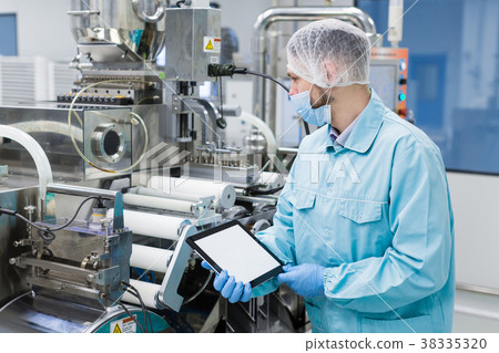 scientist near steel machine hold empty tablet scientist near steel machine hold empty tablet 38335320