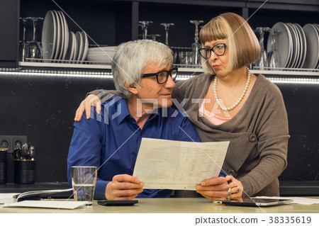 Senior couple calculate their bills Senior couple calculate their bills 38335619