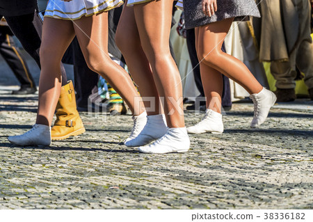 Woman in mini skirts walking in the street 38336182
