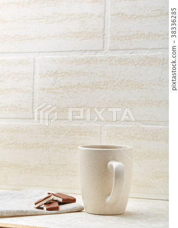 Cup of coffee and chocolate isolated on the white Cup of coffee and chocolate isolated on the white 38336285